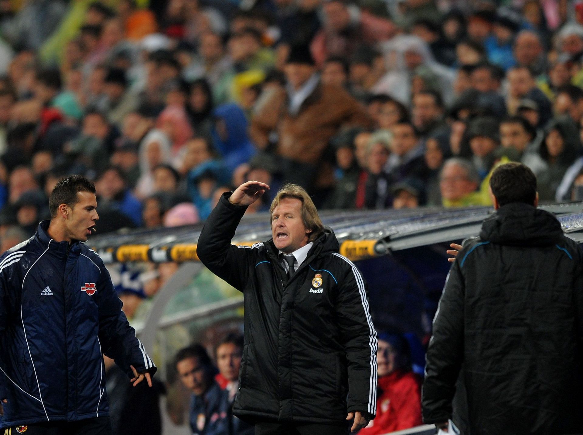 Bernd Schuster (centre) reacts in the Bernabeu dugout.